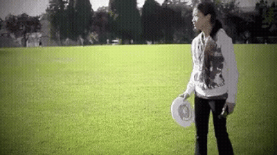 Woman Holding Frisbee In Field GIF