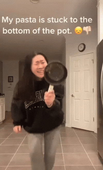 Woman Holding Frying Pan Making Funny Face GIF
