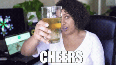 Woman Holding Glass Of Beer Saying Cheers GIF