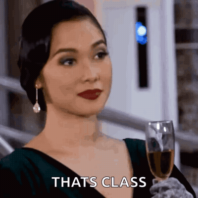 Woman Holding Glass Of Wine Saying Cheers GIF