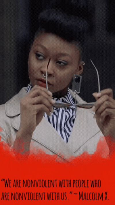 Woman Holding Glasses With Malcolm X Quote GIF