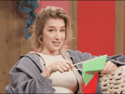 Woman Holding Green Flag With Red Triangle GIF
