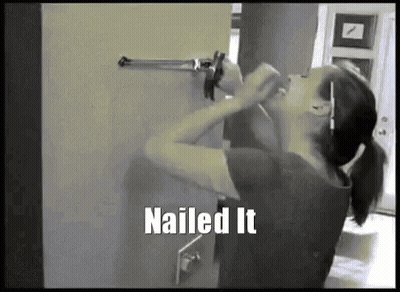 Woman Holding Gun Against Wall Saying Nailed It GIF
