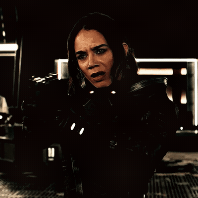 Woman Holding Gun In Dark Room GIF