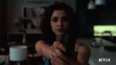 Woman Holding Gun In Front Of Face GIF