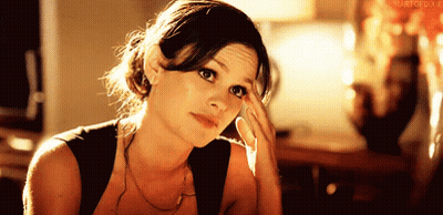 Woman Holding Hand To Forehead In Black Tank Top GIF