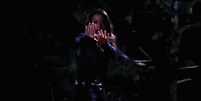 Woman Holding Hands Up In Darkness GIF