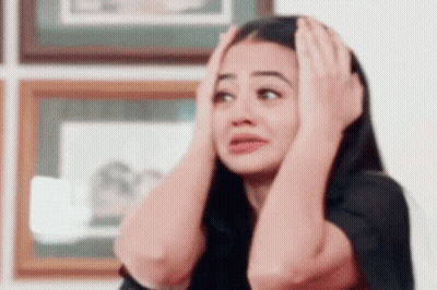 Woman Holding Head Making Funny Face GIF