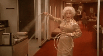 Woman Holding Hula Hoop In Hallway GIF