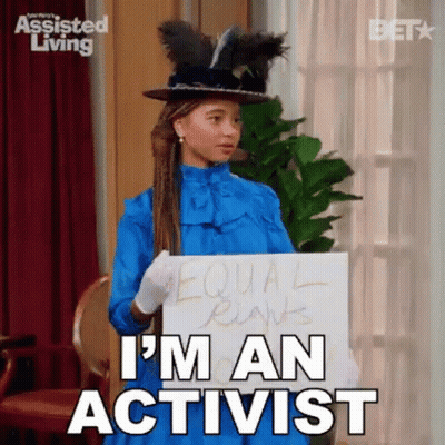 Woman Holding I'm An Activist Sign In Blue Dress And Hat GIF