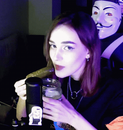 Woman Holding Jar And Cucumber At Microphone GIF
