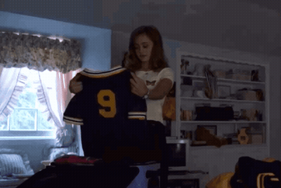 Woman Holding Jersey Number 9 GIF