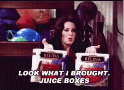 Woman Holding Juice Boxes Saying Look What I Brought GIF