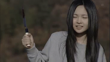 Woman Holding Knife Making Face GIF