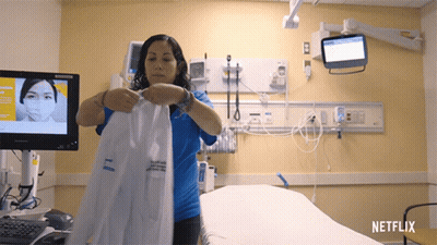 Woman Holding Lab Coat In Hospital Room With Netflix GIF