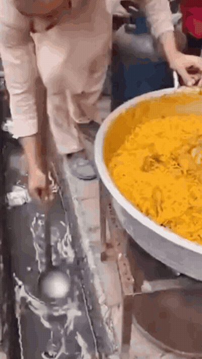 Woman Holding Ladle Over Food GIF