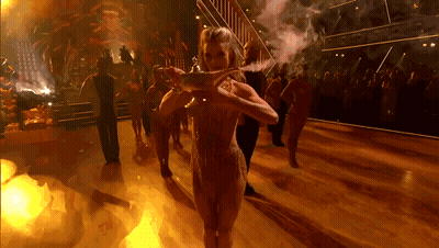 Woman Holding Lamp On Dance Floor GIF