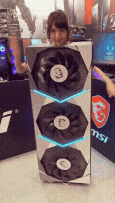 Woman Holding Large MSI Fan In Front Of MSI Sign GIF