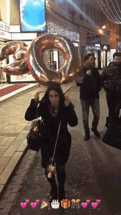 Woman Holding Large Number 10 Balloon Over Head GIF