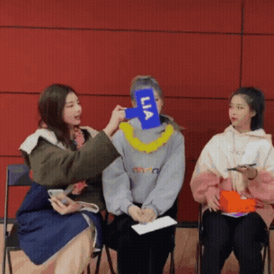 Woman Holding Lia Sign GIF