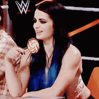 Woman Holding Lollipop In Front Of Wrestling Ring GIF