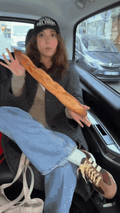 Woman Holding Long Loaf Of Bread GIF