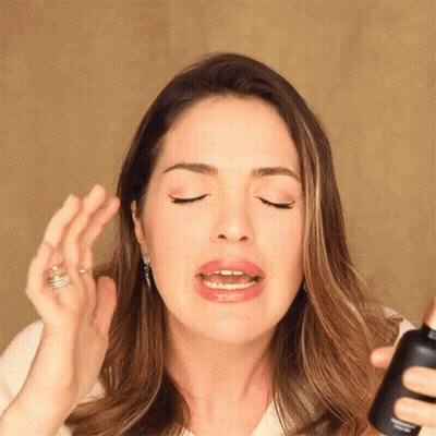 Woman Holding Lotion Bottle GIF