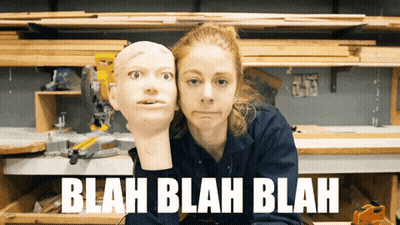 Woman Holding Mannequin Head Saying Blah Blah Blah GIF