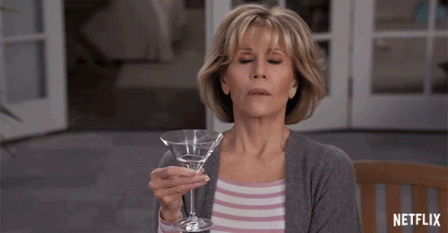 Woman Holding Martini Glass with Netflix Logo