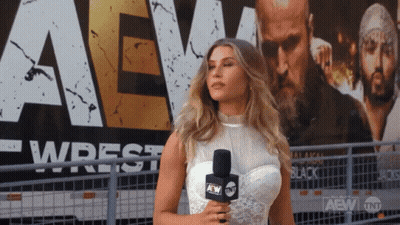 Woman Holding Microphone In Front Of AEW Sign GIF