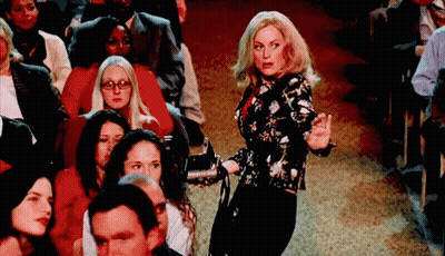 Woman Holding Microphone In Front Of Crowd GIF
