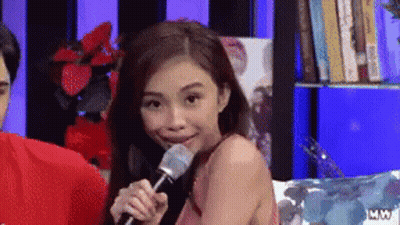 Woman Holding Microphone In Mouth Smiling GIF