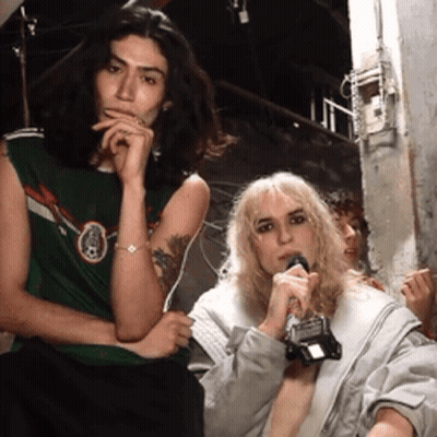 Woman Holding Microphone Next To Man In Green Shirt GIF