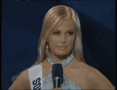 Woman Holding Microphone Wearing Sash Saying SDS GIF