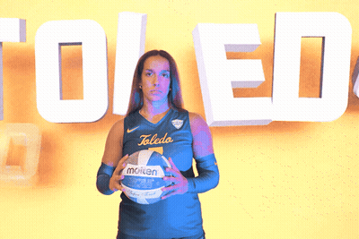 Woman Holding Molten Volleyball In Front Of Toledo Sign GIF