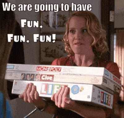 Woman Holding Monopoly And Clue Board Games GIF