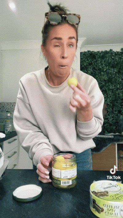 Woman Holding Mustard Jar And Oyster Can GIF