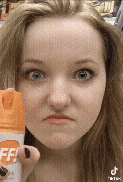 Woman Holding Off Bug Spray GIF