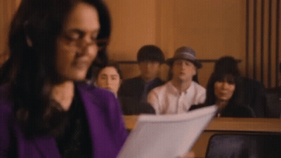 Woman Holding Paper In Front Of Group GIF