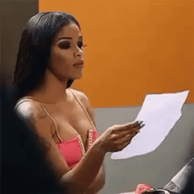 Woman Holding Paper Looking At It GIF