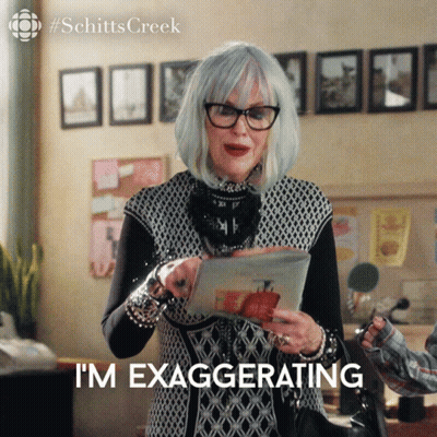 Woman Holding Paper Saying I'm Exaggerating