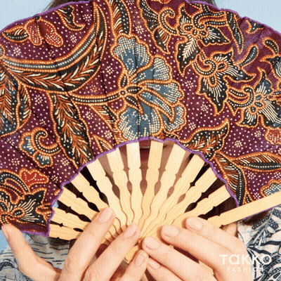Woman Holding Patterned Fan GIF