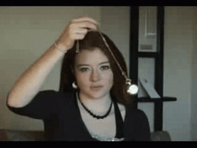 Woman Holding Pendulum With Necklace GIF