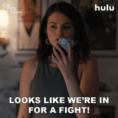 Woman Holding Phone Saying Looks Like We're In For A Fight GIF