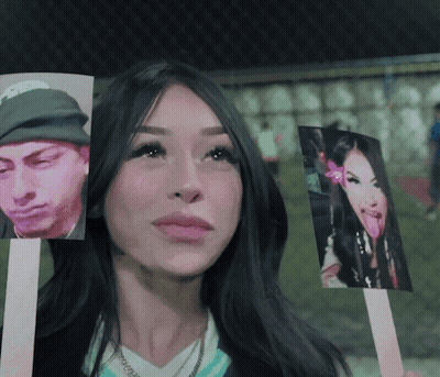Woman Holding Pictures Of Man And Woman GIF