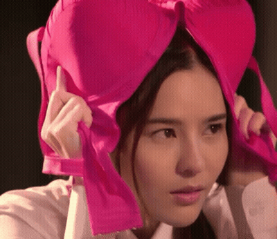 Woman Holding Pink Bra Over Head GIF