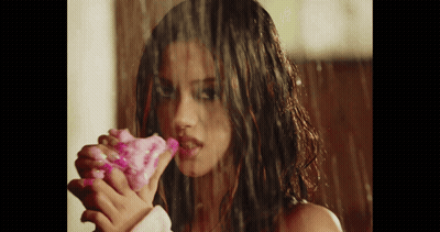 Woman Holding Pink Flower In Rain GIF