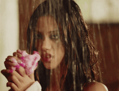 Woman Holding Pink Flower in Rain