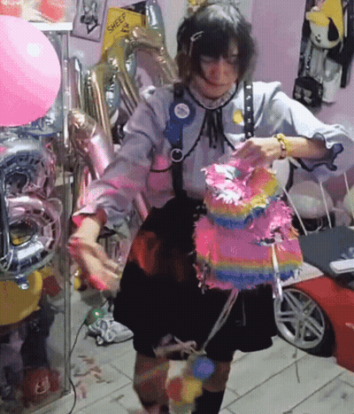 Woman Holding Pink Piñata Near Balloons And Sheep Sign GIF