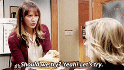 Woman Holding Plate Of Food Says Should We Try GIF